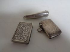 Two silver vesta cases together with a silver cigar case.