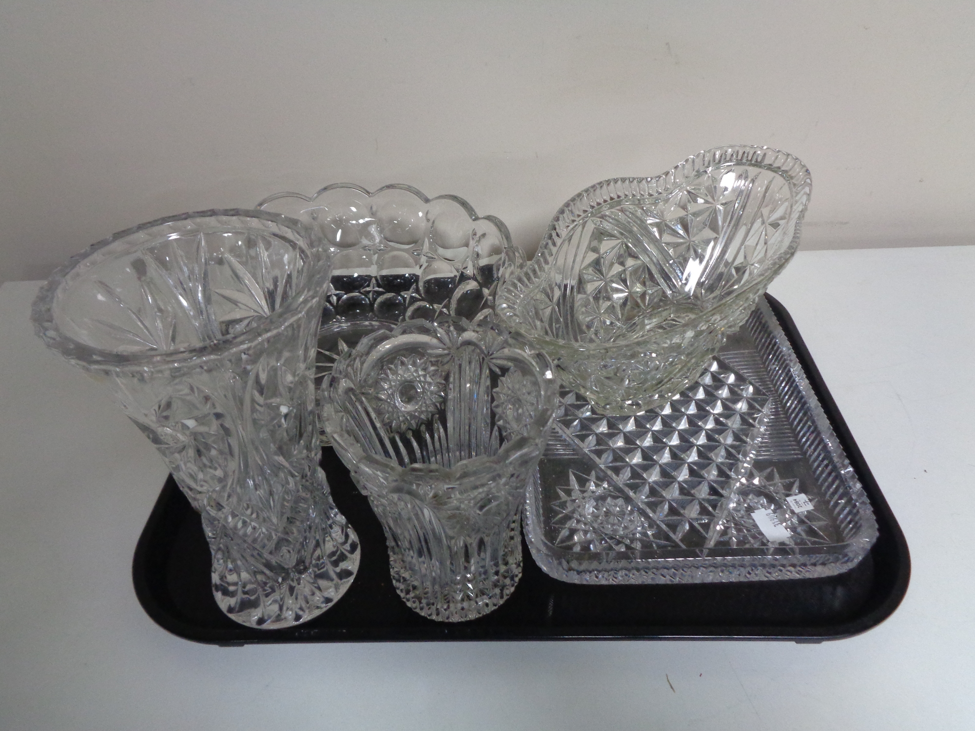 A tray containing 20th century glassware to include trinket tray, two vases and two bowls.