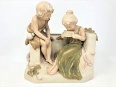 A Royal Dux figure group depicting two children playing a pipe whistle, height 24 cm.