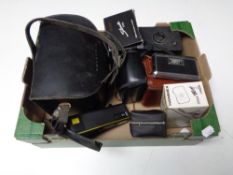 A box containing assorted cameras to include Polaroid, Kodak, Duaflex in leather case, Brownie etc.