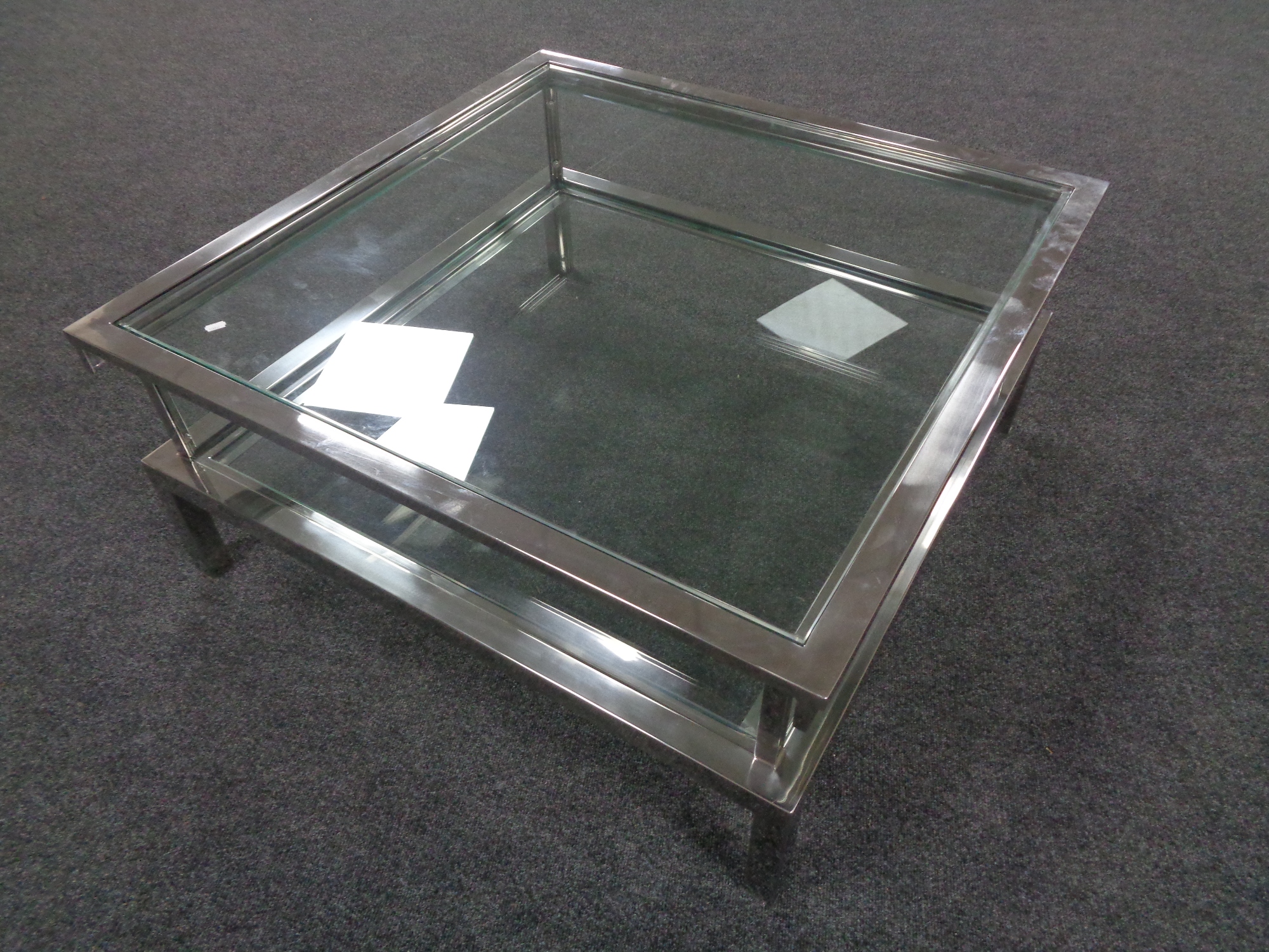 A contemporary metal framed glass display coffee table with slide top