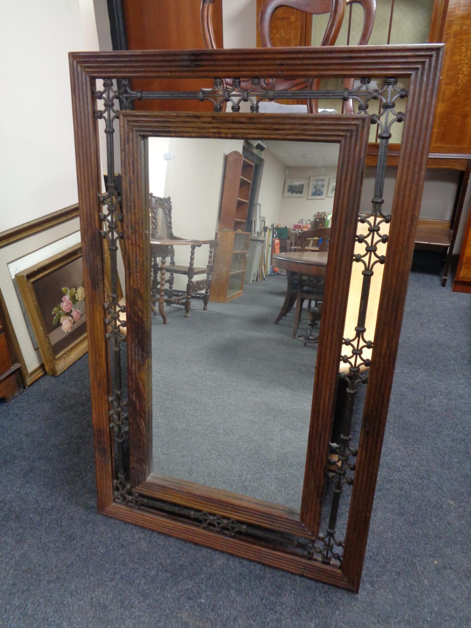 A hardwood and wrought iron framed mirror.