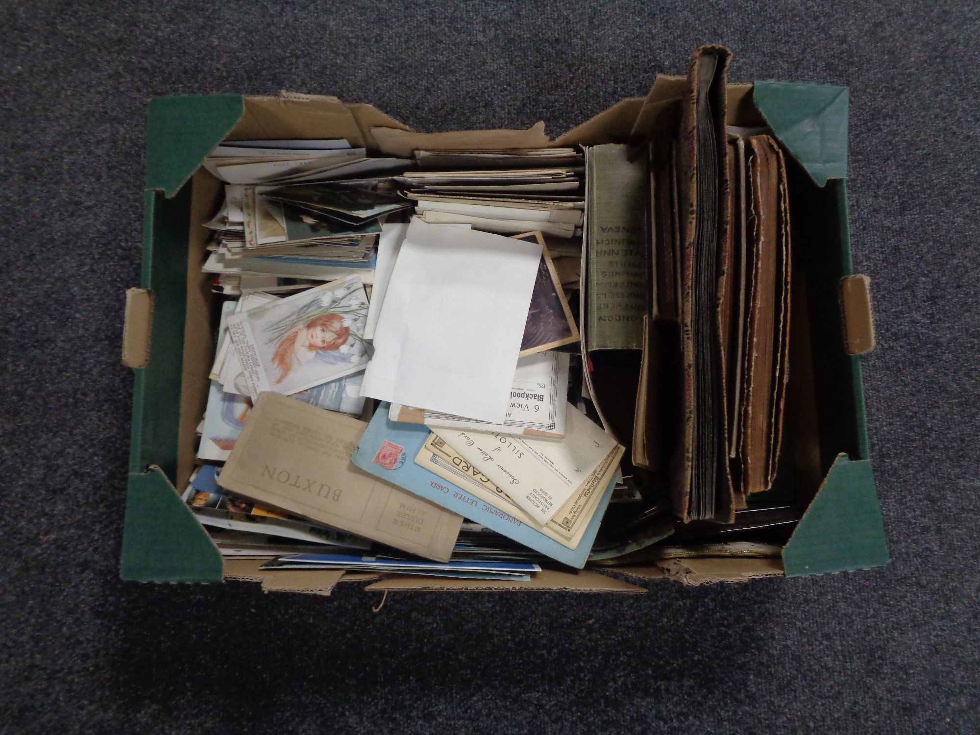 A box containing antiquarian and later postcards and monochrome photographs in albums.