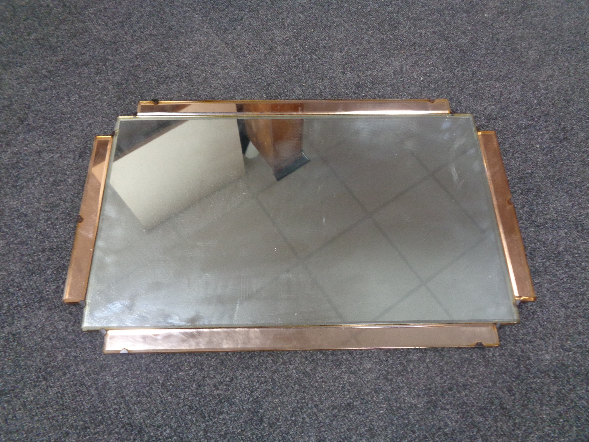 An Art Deco frameless two tone mirror.