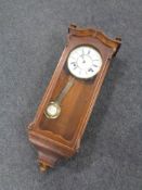 A 20th century mahogany cased eight day wall clock with brass and enamel dial.