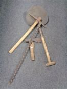 A vintage wooden handled peat shovel together with a miner's pick,