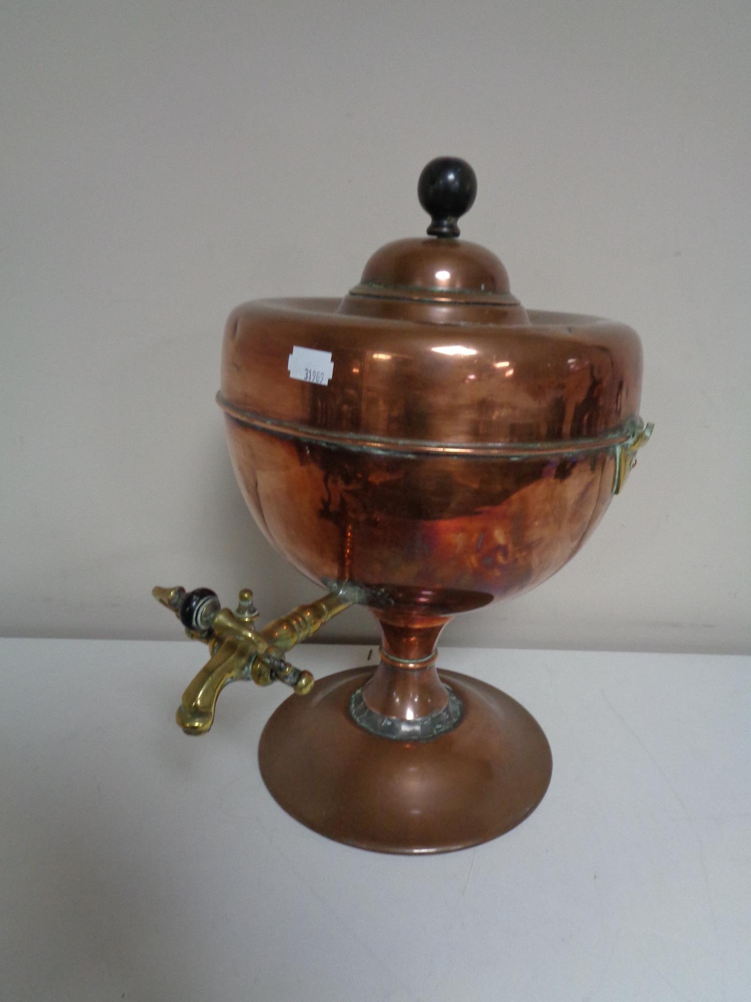 An antique copper and brass urn.