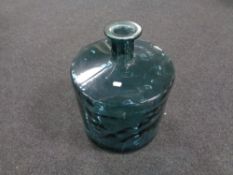 A circular blue glass floor standing vase