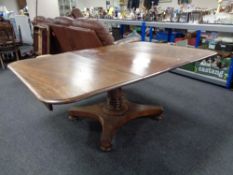 A Victorian mahogany pedestal dining table with leaf