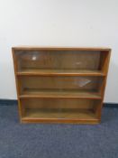 A mid 20th century sliding glass door bookcase together with a further set of bookshelves.