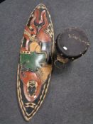 An African hand drum together with a shield