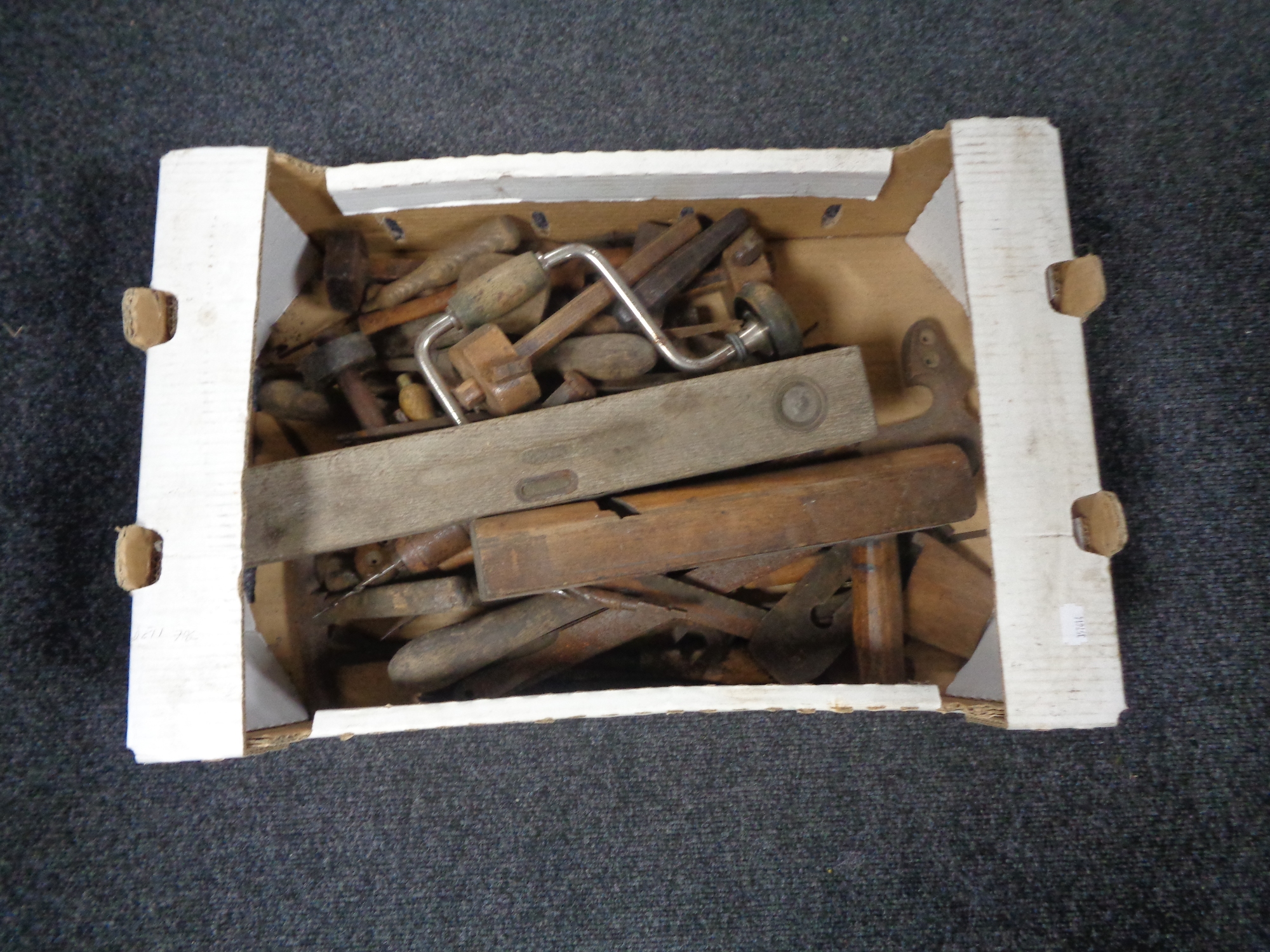 A box containing 20th century woodworking tools and spirit levels.