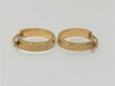 A pair of 9ct gold Greek key pattern hoop earrings.