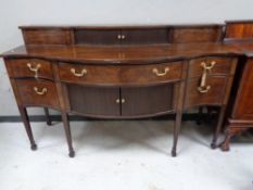 A George III style mahogany serpentine front sideboard,