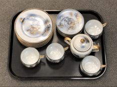 Sixteen pieces of 20'th Century Japanese tea china, gilt-rimmed with "Oriental Garden" decoration.