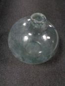 An antique glass hand blown carbouy.