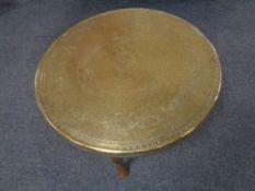 An eastern brass topped coffee table on Queen Anne legs