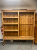 A large pine open bookcase on raised legs