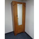 An Edwardian oak mirrored door hall wardrobe.