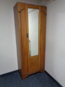 An Edwardian oak mirrored door hall wardrobe.