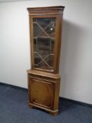 A corner display cabinet, fitted cupboard beneath.