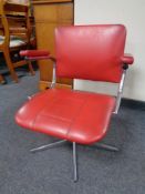 A mid 20th century tubular metal and red vinyl upholstered armchair