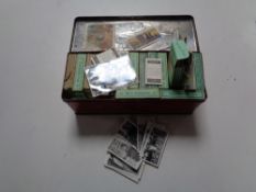 A vintage C.W.S biscuit tin containing a large quantity of Wills cigarette cards in boxes, various.