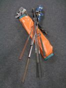 A vintage Dunlop golf bag containing assorted drivers, irons and putters.