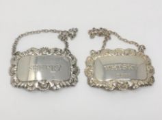 Two silver decanter labels 'Whisky' and 'Sherry', Birmingham and Sheffield marks.