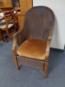 A 20th century Lloyd Loom armchair with sprung seat.