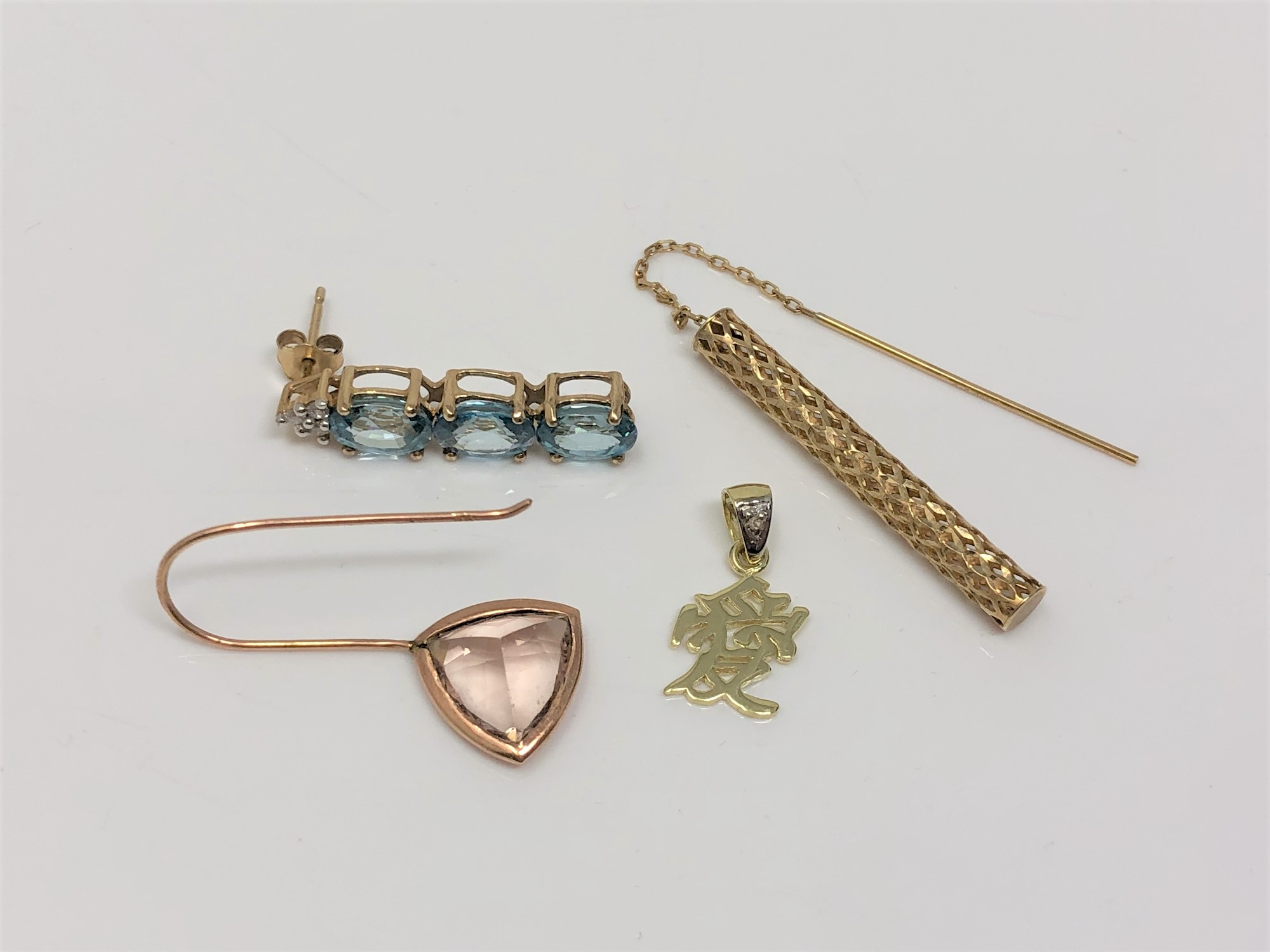 A single gold earring set with blue topaz, another set with pink topaz and two 9ct gold items.
