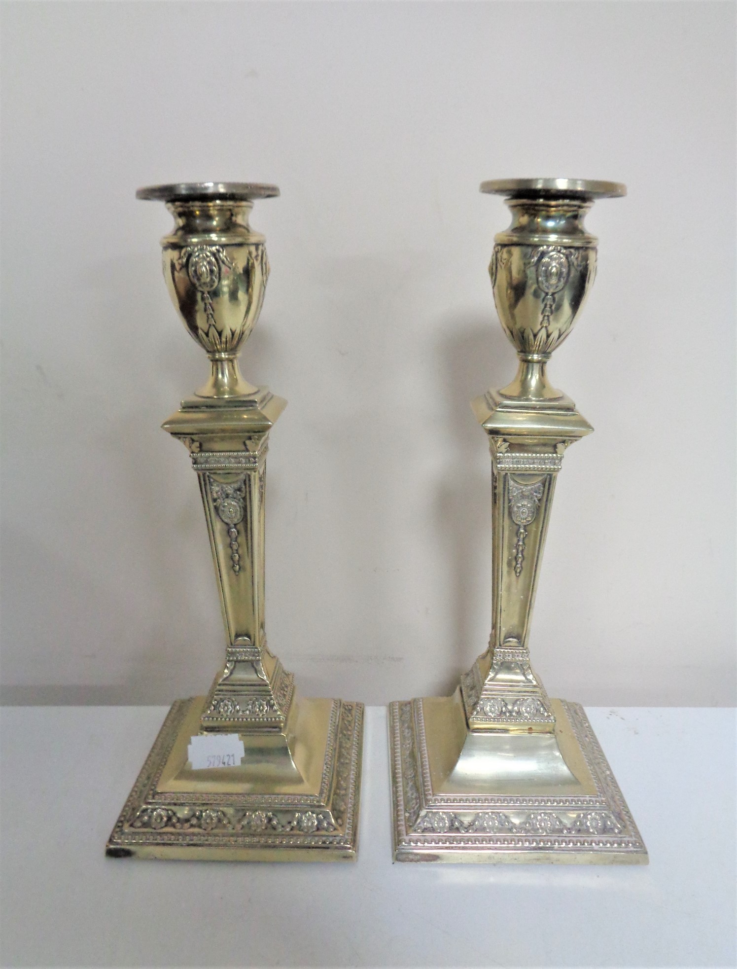 A pair of late 19th century silver plated Neo-classical candlesticks,