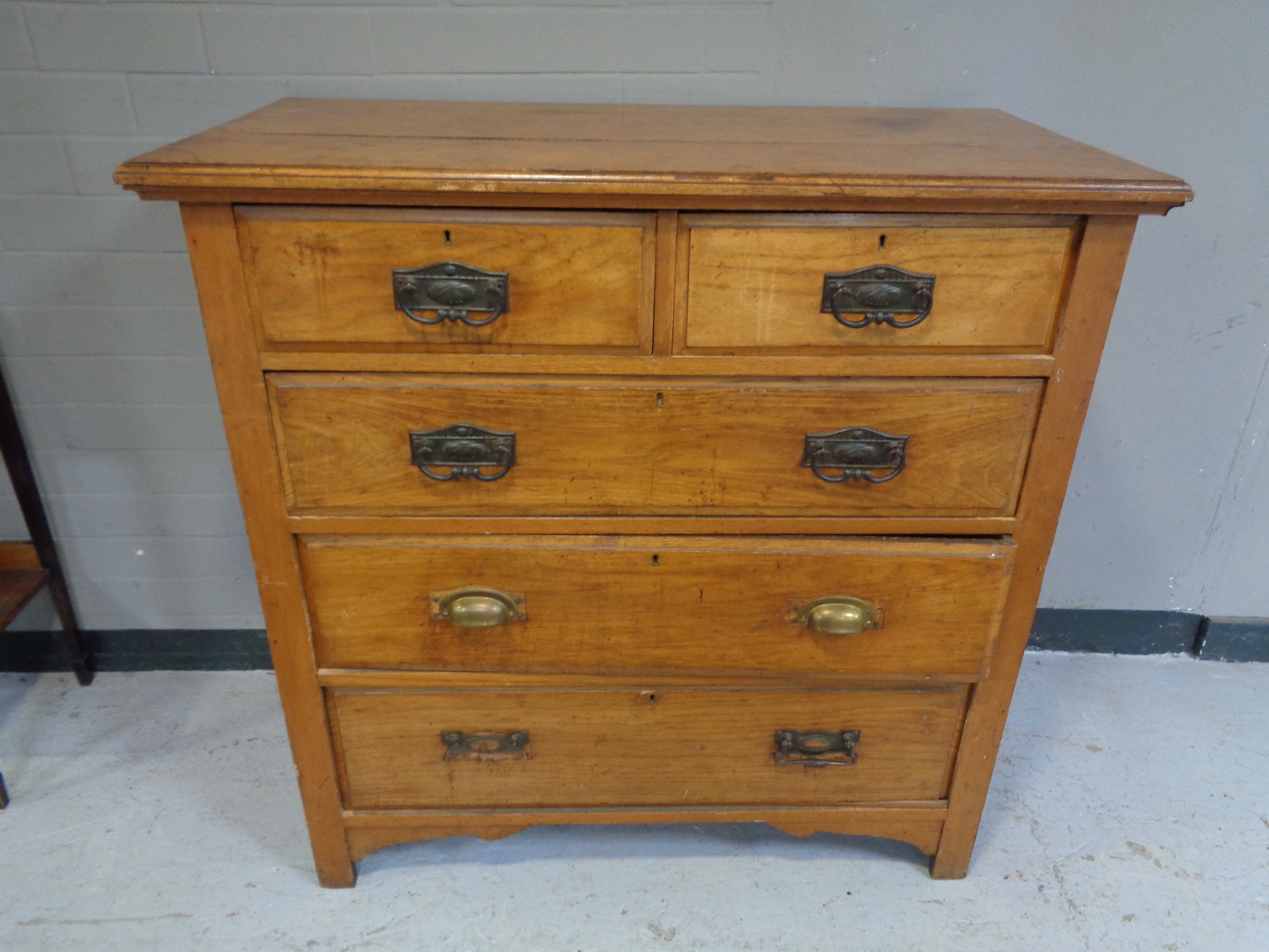An Edwardian oak five drawer chest