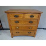 An Edwardian oak five drawer chest