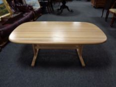 A large oval pine coffee table with under stretcher.