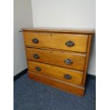 An Edwardian satinwood three drawer chest.