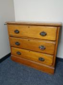 An Edwardian satinwood three drawer chest.