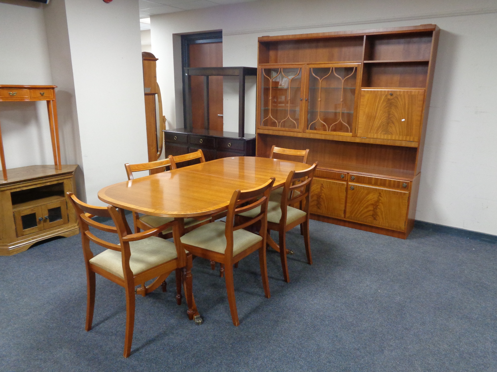 An eight piece late 20th century dining room suite comprising of wall unit,