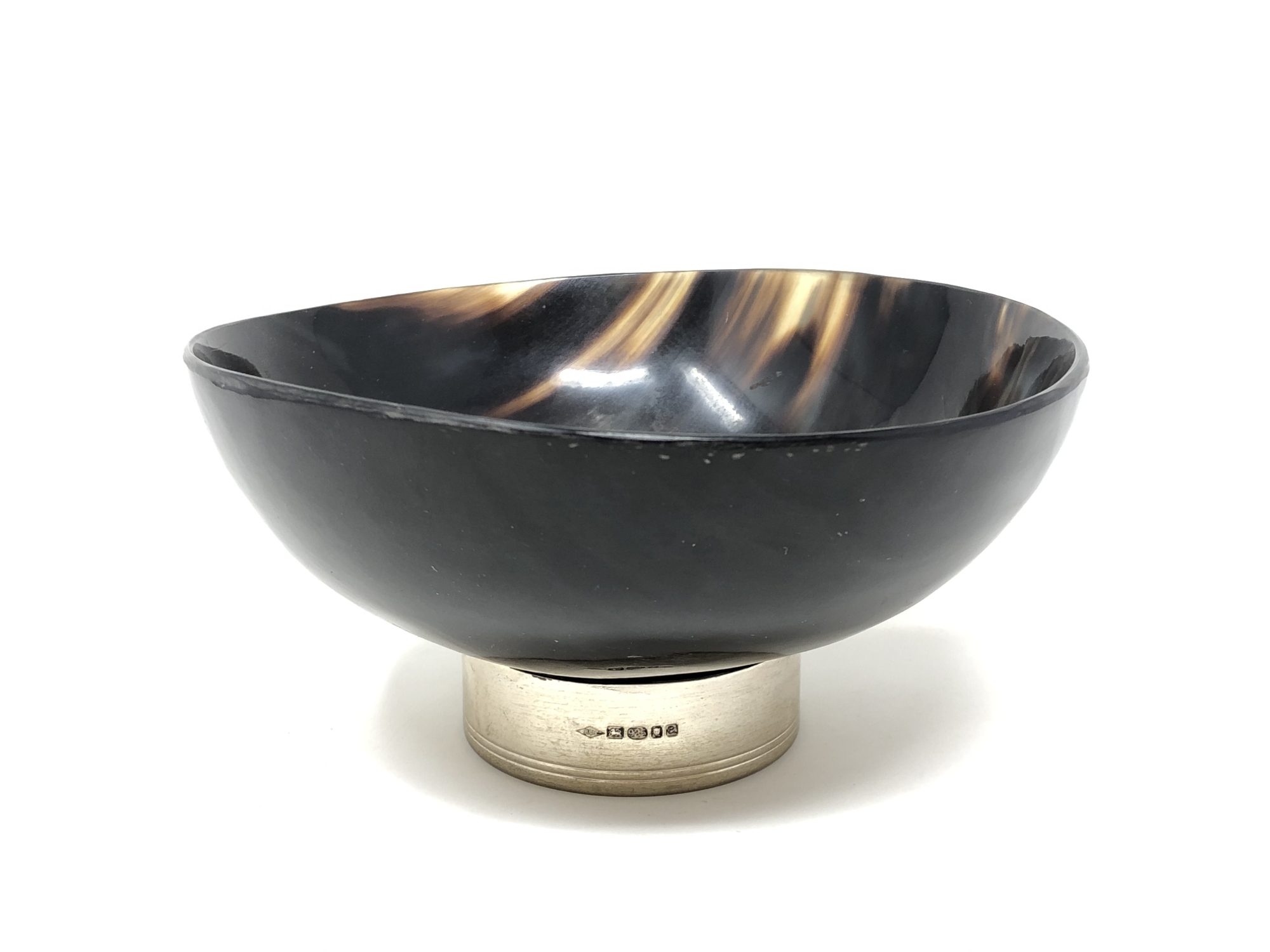 A polished horn bowl standing on a silver base, diameter 16.5 cm, height 8 cm, London 2004.