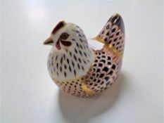 A Royal Crown Derby paperweight of a hen with silver stopper