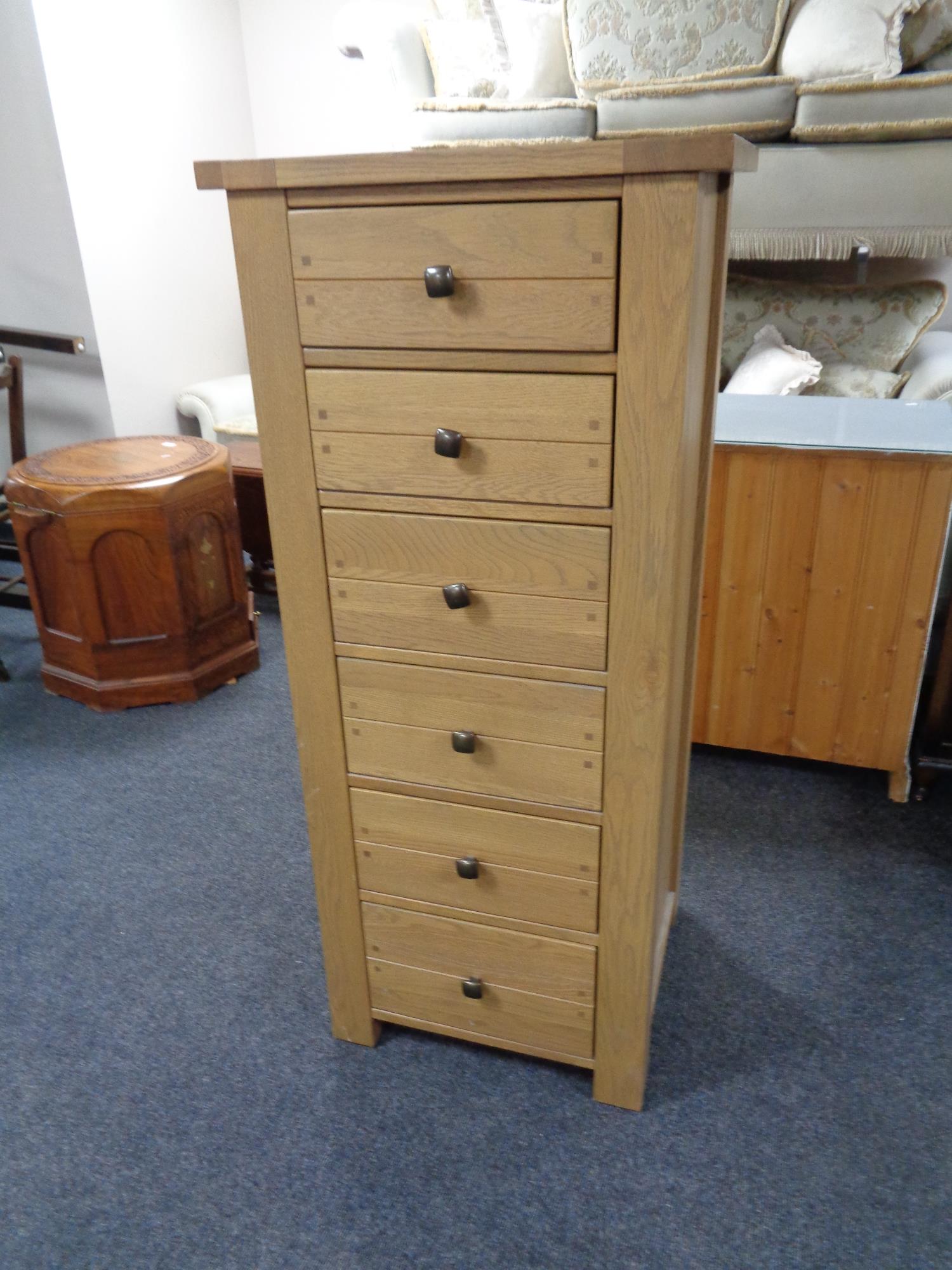 A Willis & Gambier oak narrow six drawer chest.