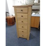 A Willis & Gambier oak narrow six drawer chest.