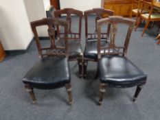 A set of ten Victorian mahogany carved dining chairs with faux black leather seats