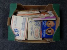 A box containing a large quantity of cigarette cards and tea cards in albums.
