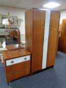 A mid 20th century double door wardrobe and matching three drawer dressing chest with a melamine