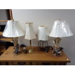 A pair of contemporary table lamps with shades modelled as sheet music with cello and sheet music