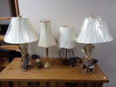 A pair of contemporary table lamps with shades modelled as sheet music with cello and sheet music