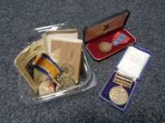 A group of medals and collectables to include - Two Motor fuel ration books, Faithful service medal,