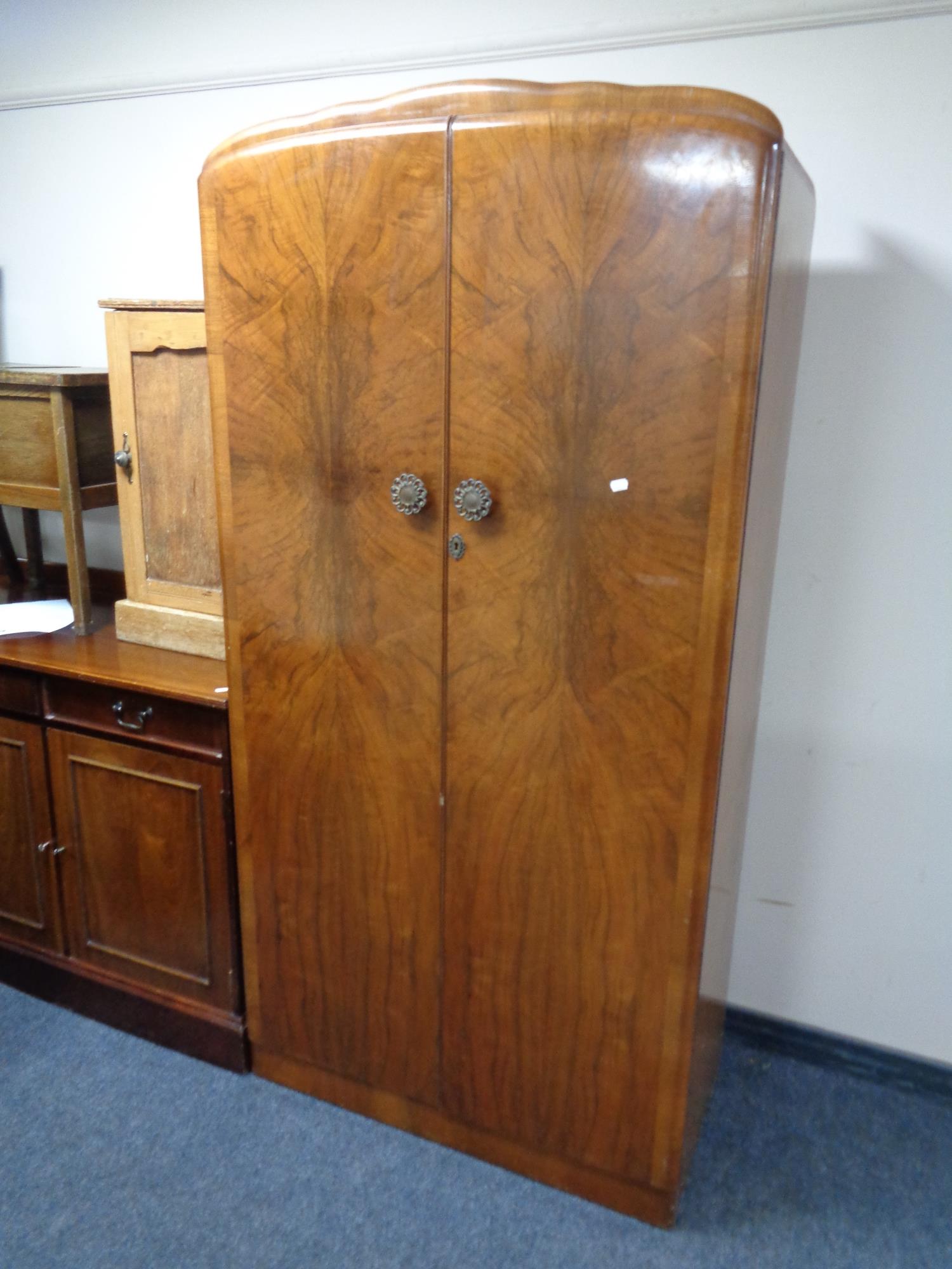 A 1930s walnut double door gentleman's wardrobe.