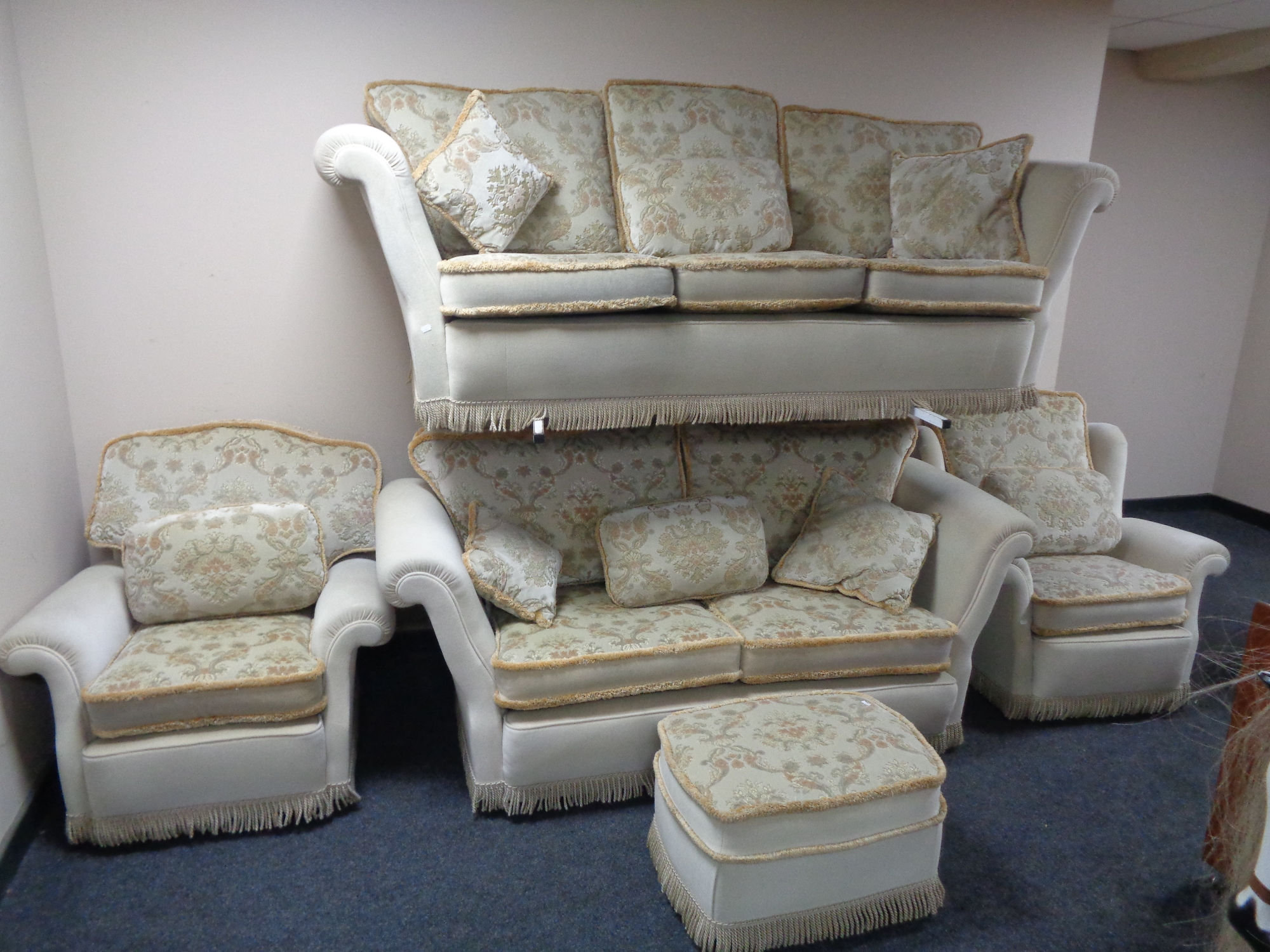 A five piece cream floral dralon lounge suite comprising of three seater settee, two seater settee,